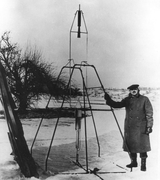 Robert Goddard poses with a liquid oxygen-gasoline rocket in its launching frame on March 16, 1926, at Auburn, Massachusetts (NASA)